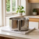 Best way to clean an air fryer basket shown with a soft sponge and warm soapy water