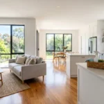 A bright and tidy living room with clean surfaces, folded cushions, and sparkling floors after a fast house cleaning session.
