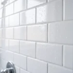 Clean white shower tiles with fresh grout lines and no mold