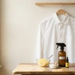 Natural ingredients like lemon, baking soda, and vinegar used to remove sweat stains from a white cotton shirt
