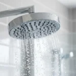 Clean shower head with water flowing evenly after being cleaned with vinegar