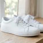 Close-up of clean white sneakers being washed and cared for at home