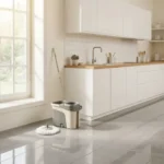 Clean kitchen tile floor with mop and bucket showing regular floor mopping routine